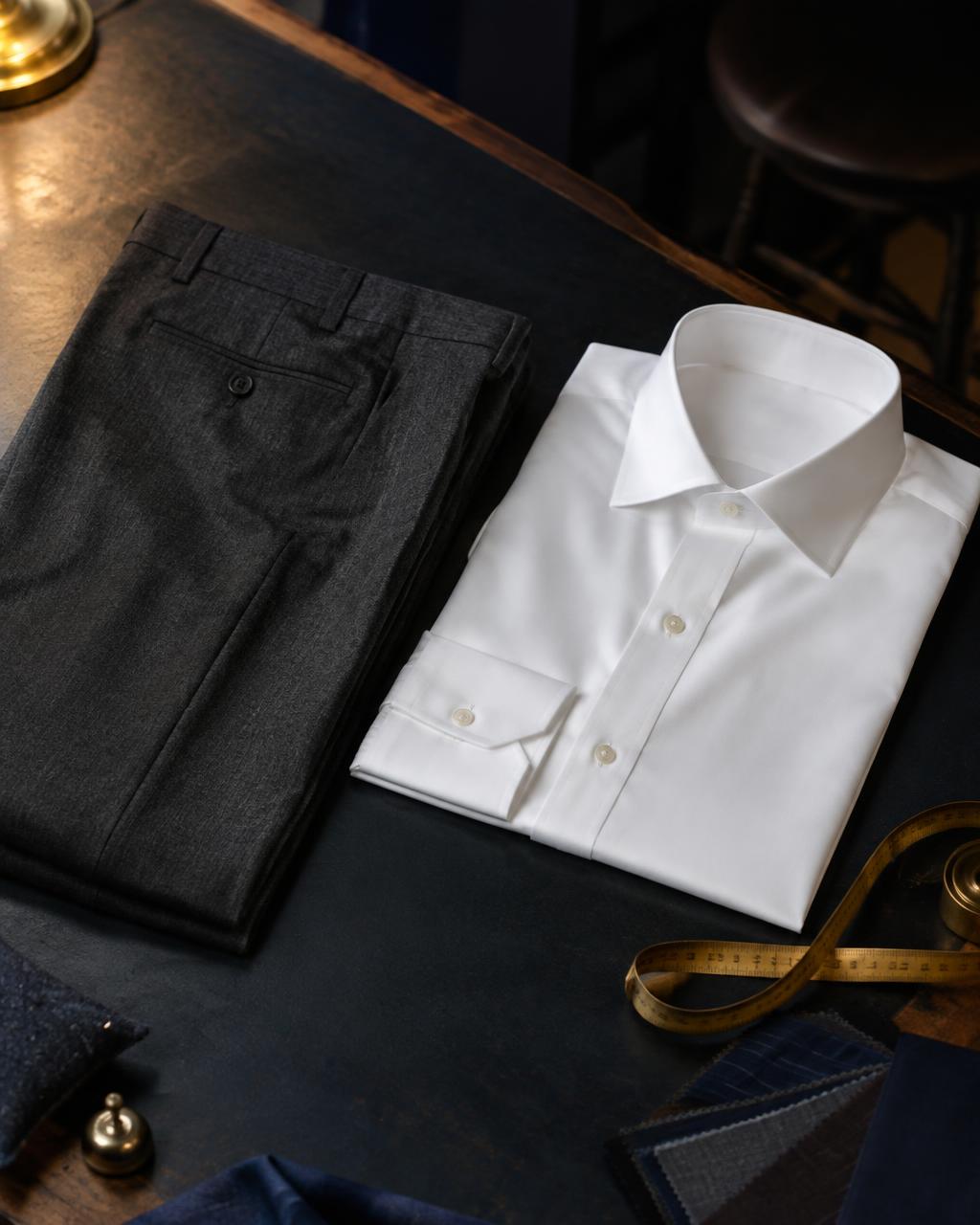 Pressed white shirt and charcoal trousers